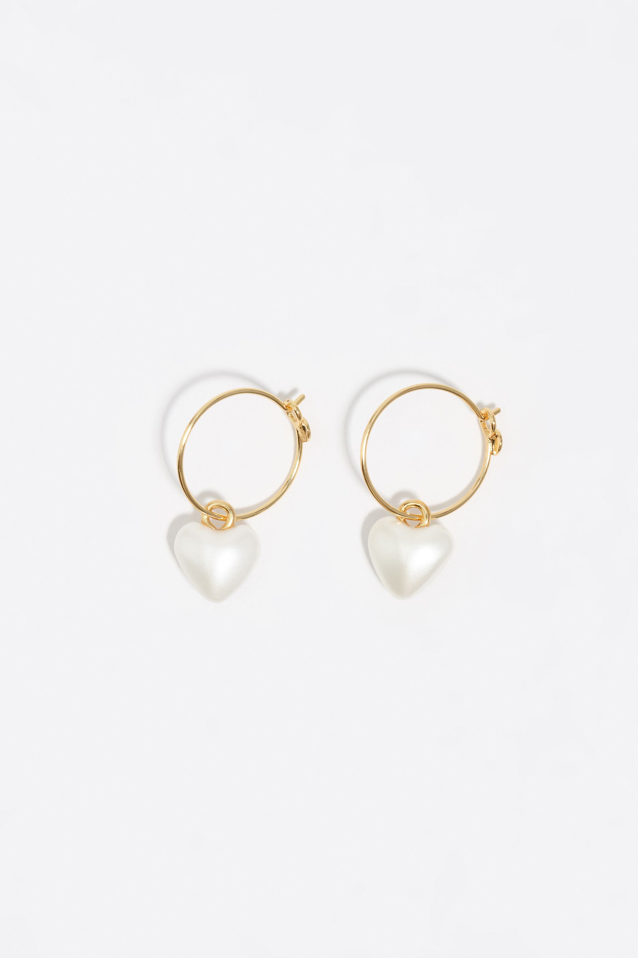 Gold hoop earrings and pearl heart