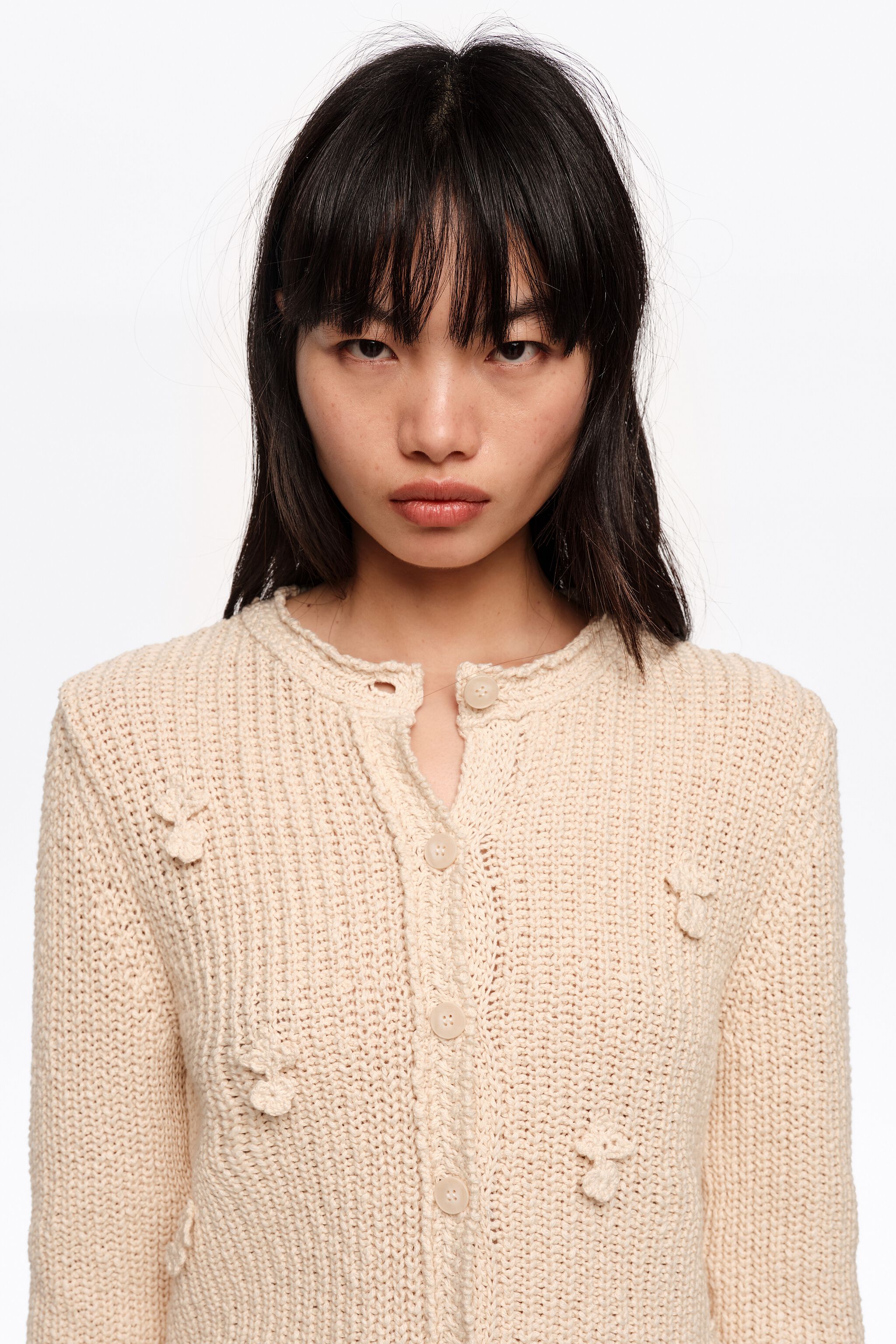 Beige cotton cardigan with flat bobbles