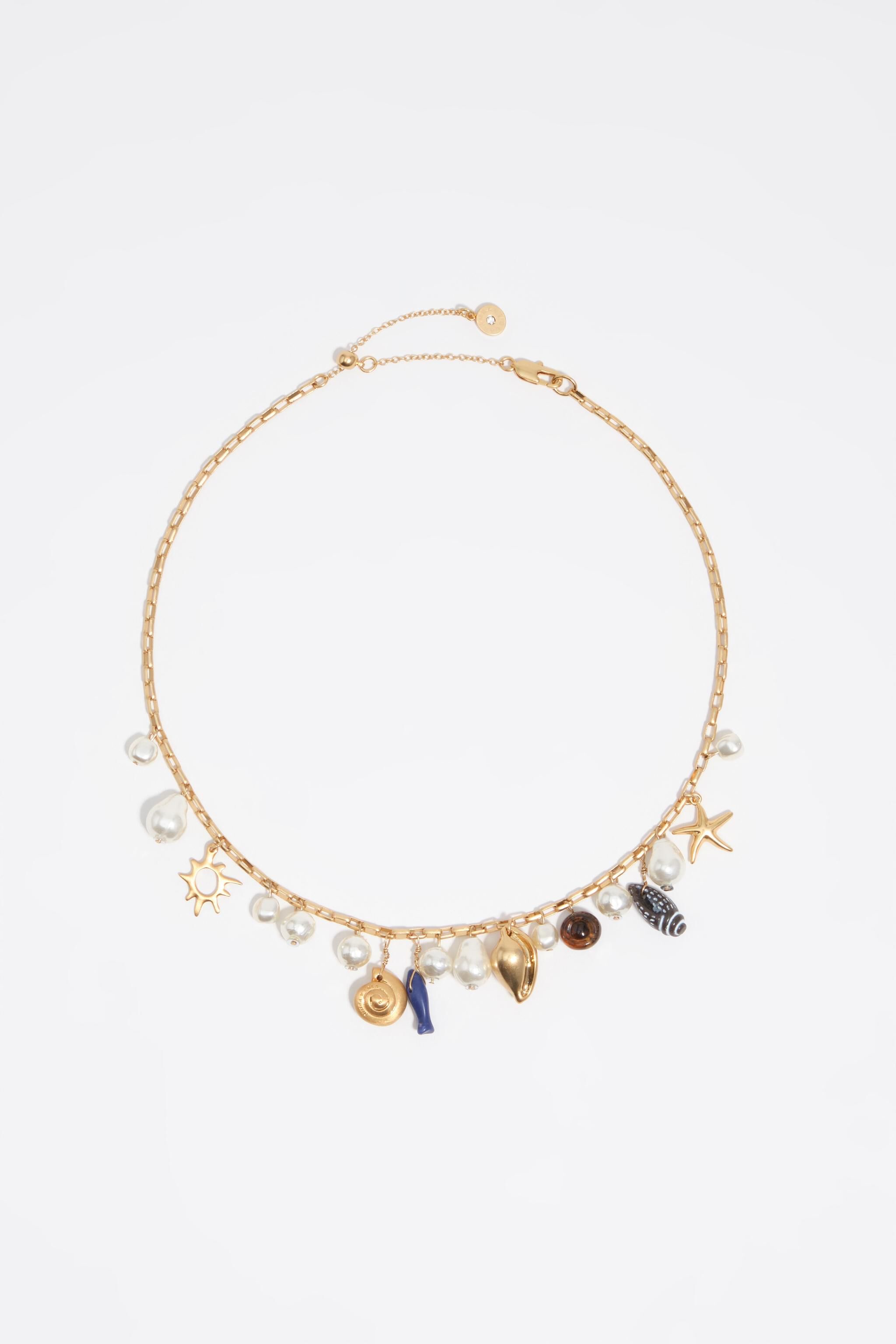 Aged gold necklace with shells and fish