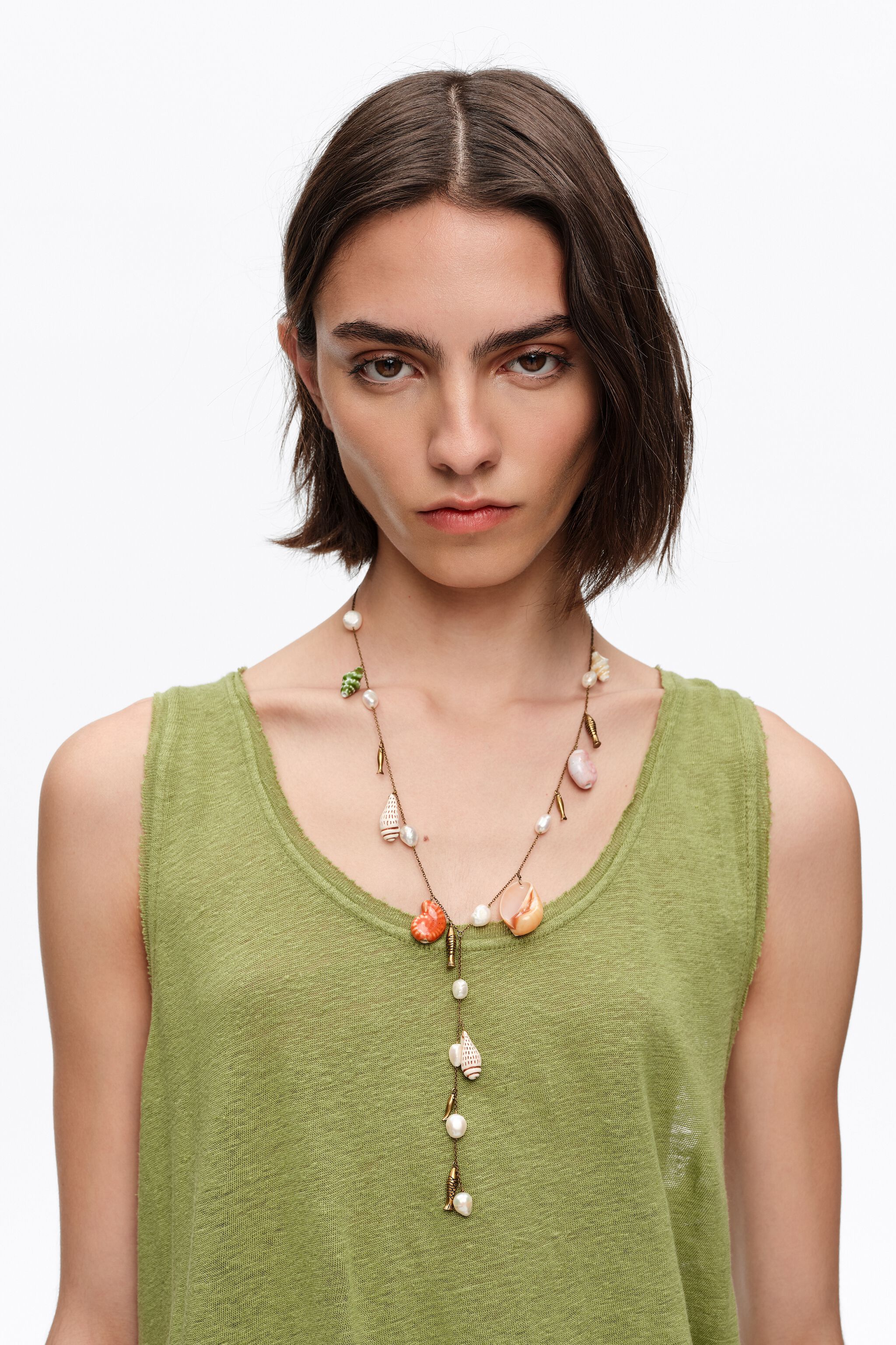 Aged gold necklace with ceramic fish and shells