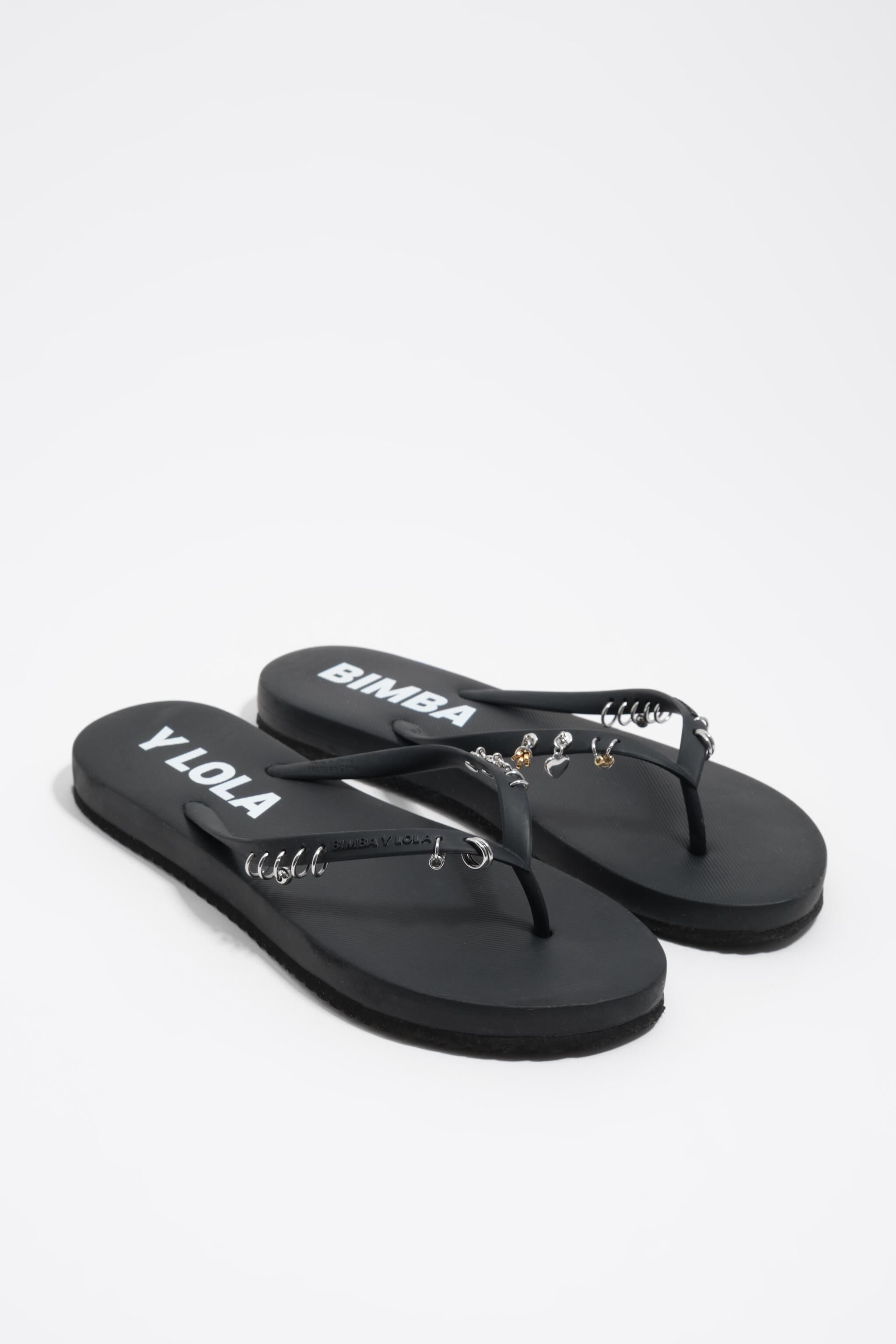 Black flip-flop with piercings